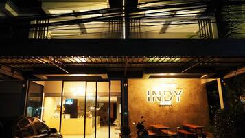 A building with a sign reading 'INDY' and a covered outdoor seating area.
