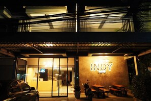 A building with a sign reading 'INDY' and a covered outdoor seating area.