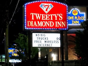 A hotel sign with 'TWEETY'S DIAMOND INN' and 'ONE PLACE INN' logos, indicating a single establishment. - TWEETYS DIAMOND INN-NRG (Houston)