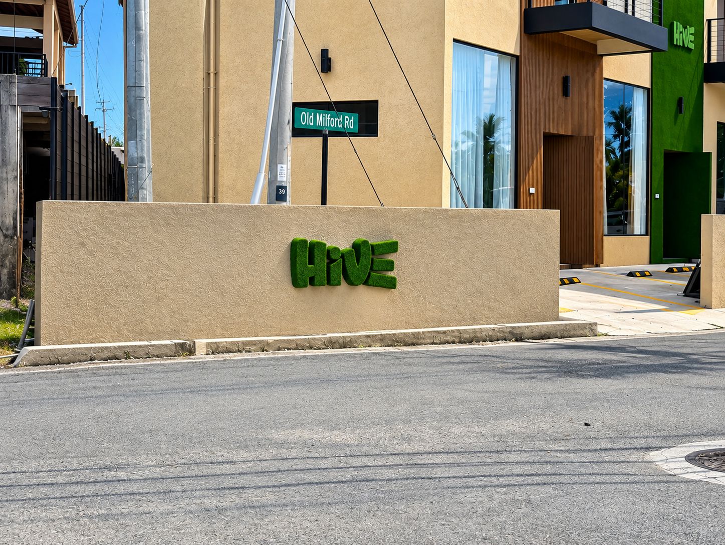 A building with a sign for 'Old Milford Rd' and a large 'HIVE' sign on the facade.