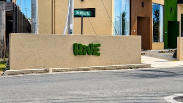 A building with a sign for 'Old Milford Rd' and a large 'HIVE' sign on the facade.