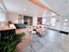A modern kitchen with a dining area, a pool table, and a large window. - House with pets allowed - 6 guests (Hasnon)