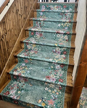 A staircase with a floral carpet. - Parkville Group Getaway - Sleeps 12 with 12 Individual Workstations (Parkville)