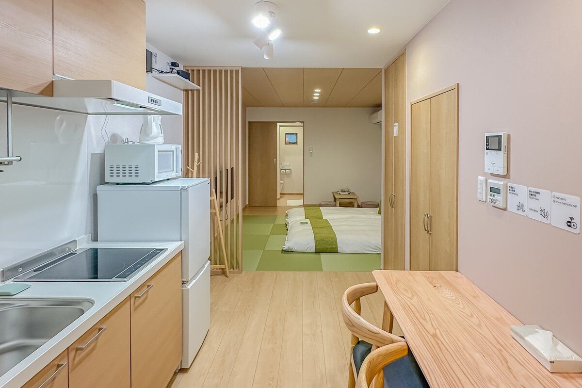 A modern kitchen with a dining area, wooden cabinets, and a wooden dining table with chairs.