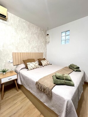 A bedroom with a bed, bedside table, and a window. - Beautiful Apartment II: Free Welcome Package (Torremolinos)
