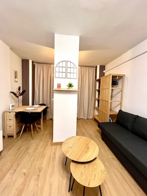 A modern living space with a dining area, a sofa, and a small table. - Beautiful Apartment II: Free Welcome Package (Torremolinos)