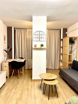 A compact living space with a dining area, a sofa, a small table, and a bookshelf. - Beautiful Apartment II: Free Welcome Package (Torremolinos)