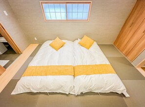 A room with a bed, a window, and a wooden wardrobe. - HANASTAY TAKE (Osaka)