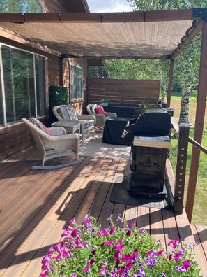 A covered patio with outdoor furniture, a grill, and a wooden deck. - NEW LISTING! Lakefront Home for Rest and Recreation (Pagosa Springs)