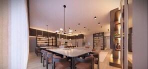 Una cucina moderna con isola centrale, elettrodomestici integrati e illuminazione a sospensione.