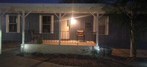 A house with a porch, a welcome sign, and a chair. - The Colorado Cowboy Hideaway - a 3 bed, 2 bath gem located in Bullhead City! (Bullhead City)