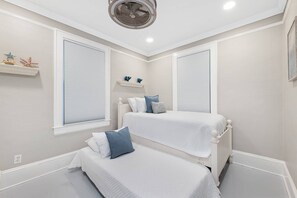 A bedroom with two beds, a ceiling fan, and a window with blinds. - Charming Updated Historic Home, Walk to Downtown, Shops, and Restaurants, $300 in Free Tickets! (St. Augustine)