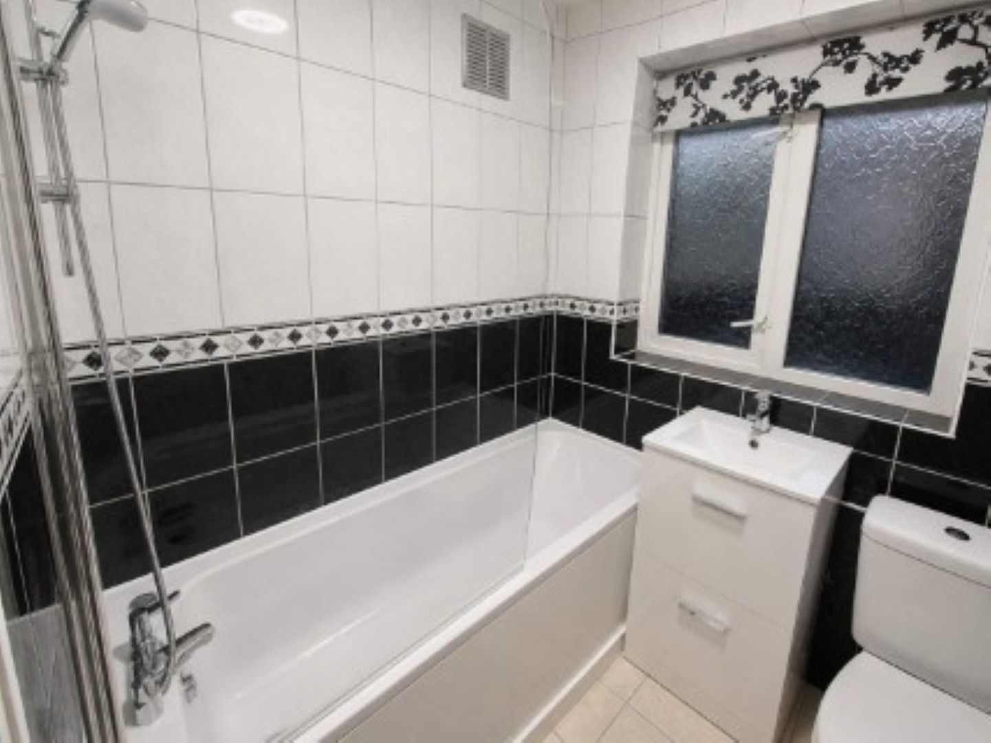 A bathroom with a bathtub, a sink, and a toilet.