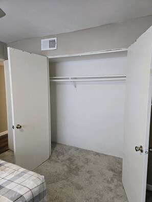 A room with a closet, carpeted floor, and a door with a doorknob. - Charming Bedroom in shared 2 bed 1 bath apartment by the Galleria! (Houston)