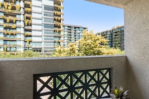 A modern building with balconies covered in greenery, a clear sky, and a view of other buildings. - Walk to Kierland | Dining+ Pool + Hot Tub | Westin (Scottsdale)
