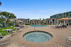A pool area with lounge chairs and umbrellas, surrounded by modern buildings. - Walk to Kierland | Dining+ Pool + Hot Tub | Westin (Scottsdale)