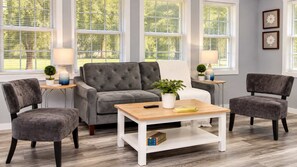 A living room with a grey sofa, two armchairs, a coffee table, and two side tables with lamps and plants. - Cozy Georgetown 3BR Near Rehoboth Beach (Georgetown)