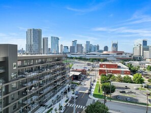A multi-story building with a modern architectural design, featuring a mix of glass and metal facades. - Bluebird By Broadway in Downtown Nash & Enjoy Pool, Gym, Parking. Walk to Broadway! (Nashville)