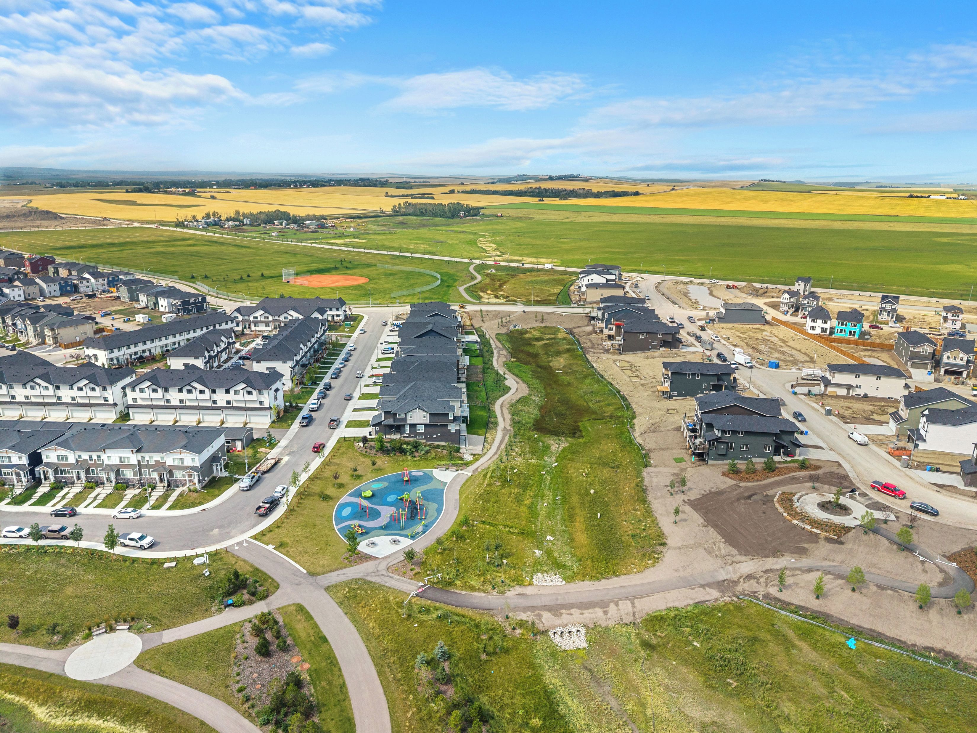 A residential area with multiple houses, roads, and a playground.