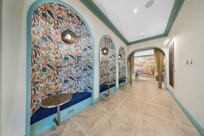 A hallway with arched ceilings, patterned walls, and a tiled floor. - NoMad Wynwood Studio Suite with Balcony & Rooftop Pool (Miami)