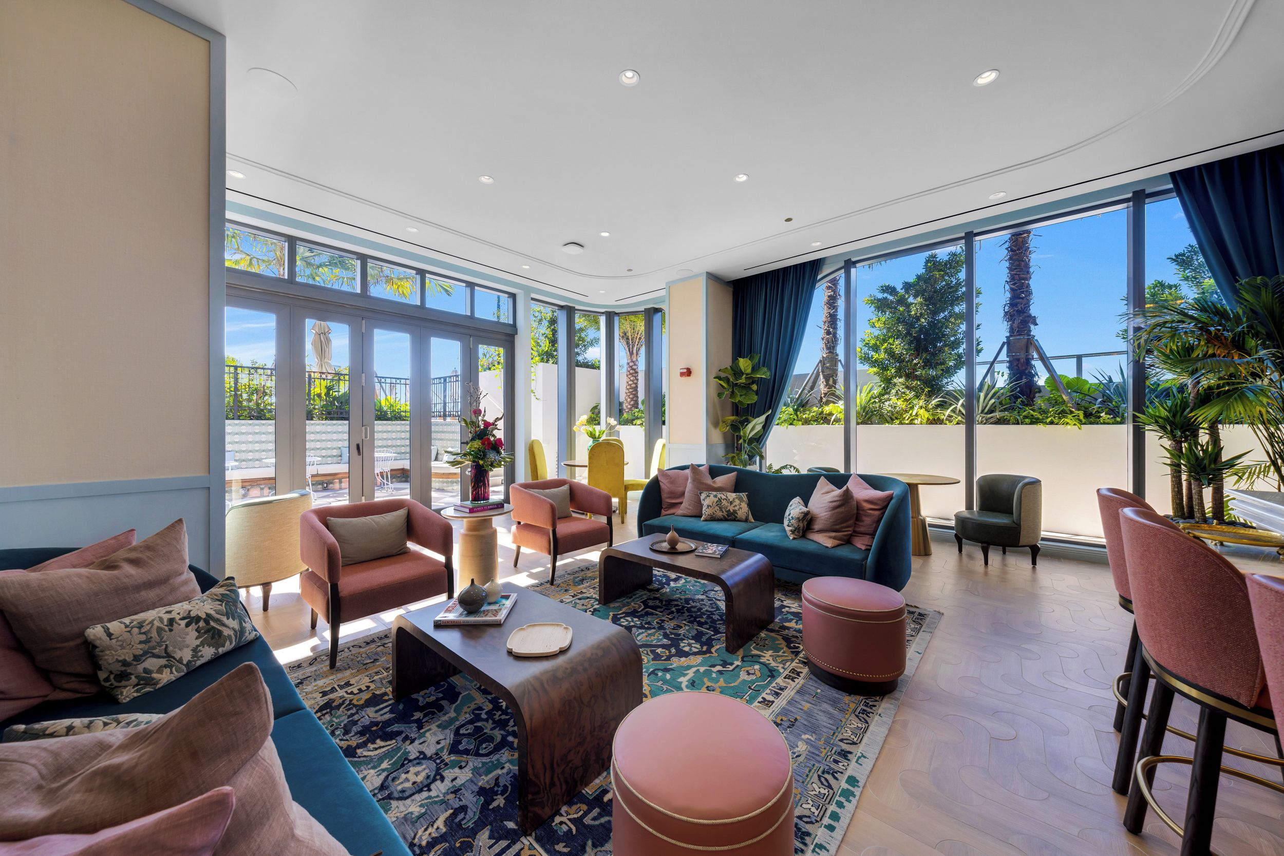 A spacious living area with a large sofa, armchairs, and a coffee table.