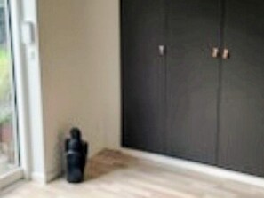 A room with a sliding door, a small table, and a chair. - 4 Star Holiday Home in Gilleleje (Gilleleje)