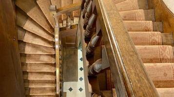 A spiral staircase with wooden steps and a wooden handrail.