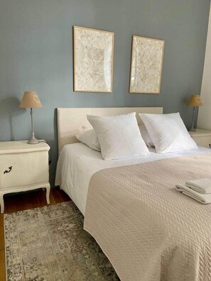 A bedroom with a bed, two nightstands, a lamp on each, and two wall-mounted artworks. - «Duchesse Anne» 5* castle-facing Suite, 8 guests (Blois)