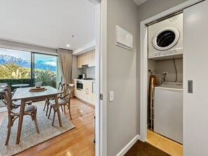 Convenient in-apartment laundry beside the dining area - Newly Renovated Lakefront Retreat, Sleeps 2 (Queenstown)