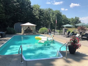 A rectangular swimming pool with a slide, surrounded by lounge chairs and a gazebo. - Hudson Landing - Fireplace & Catskills Retreat (Saugerties)
