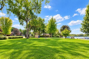 A park with a gazebo, a grassy lawn, and a lake view. - Pink Skies Landing | Steps to Powers Lake Beach (Genoa City)