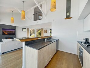 A modern kitchen with a central island, built-in appliances, and pendant lighting. - Alpine Lakeview Villa, 3 Bed, Queenstown (Queenstown)