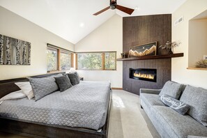 A bedroom with a bed, a sofa, a fireplace, and a ceiling fan. - NEW Cloud 9 Cabin in Warrior's Mark near Peak 9 & 10. Amazing Views & Mtn Access! (Breckenridge)
