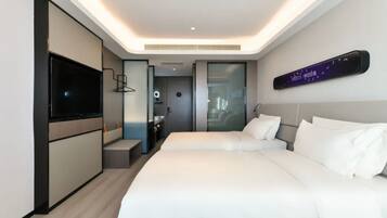 A modern hotel room with a large bed, a TV, and a digital clock on the wall.
