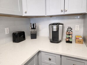 A kitchen with a toaster, a coffee maker, and a tea station. - Stylish 3BR Retreat w/ Backyard Near MetLife, American Dream & NYC (Belleville)