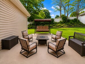 An outdoor patio with a table and six chairs, a pergola with a bench, and a well-maintained lawn. - Stylish 3BR Retreat w/ Backyard Near MetLife, American Dream & NYC (Belleville)