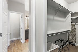 A room with a white door, a closet with a hanging rack, and a small ironing board. - 4BR, 4BA villa in Sienna Hills with pool, hot tub & resort amenities. (Washington)