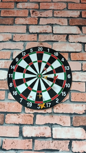 A dartboard mounted on a brick wall. - New Studio República Copan- Mackenzie (São Paulo)