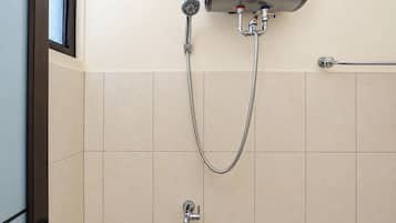 A shower with a handheld showerhead and a wall-mounted faucet.