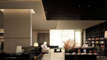 A modern living room with a fireplace, a sofa, a coffee table, and a bookshelf.