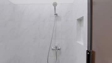 A shower with a handheld showerhead and a wall-mounted faucet.