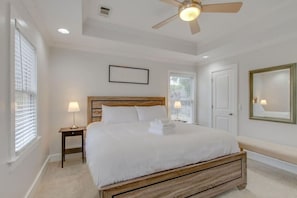 A bedroom with a bed, bedside lamps, a ceiling fan, and a window with blinds. - Two Modern Home Retreat Near Downtown! Sleeps 18! (Nashville)