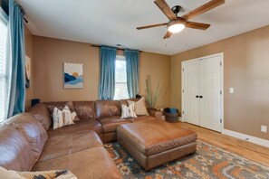 A living room with a sectional sofa, a ceiling fan, and a patterned rug. - Nashville Getaway | Spacious 3BR + 3BA Home (Nashville)