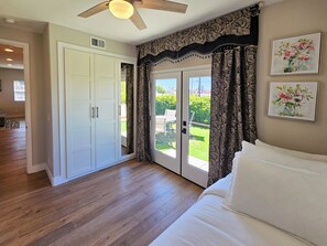 A bedroom with a bed, a ceiling fan, a sliding glass door leading to a patio, and a white wardrobe. - Rooftop sunsets, central to all of San Diego (San Diego)