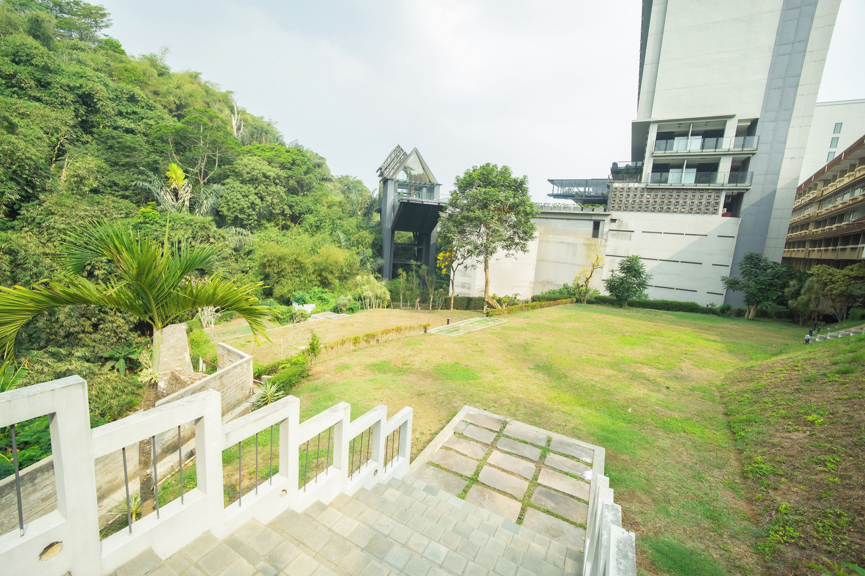A multi-level building with a staircase leading to a rooftop garden.