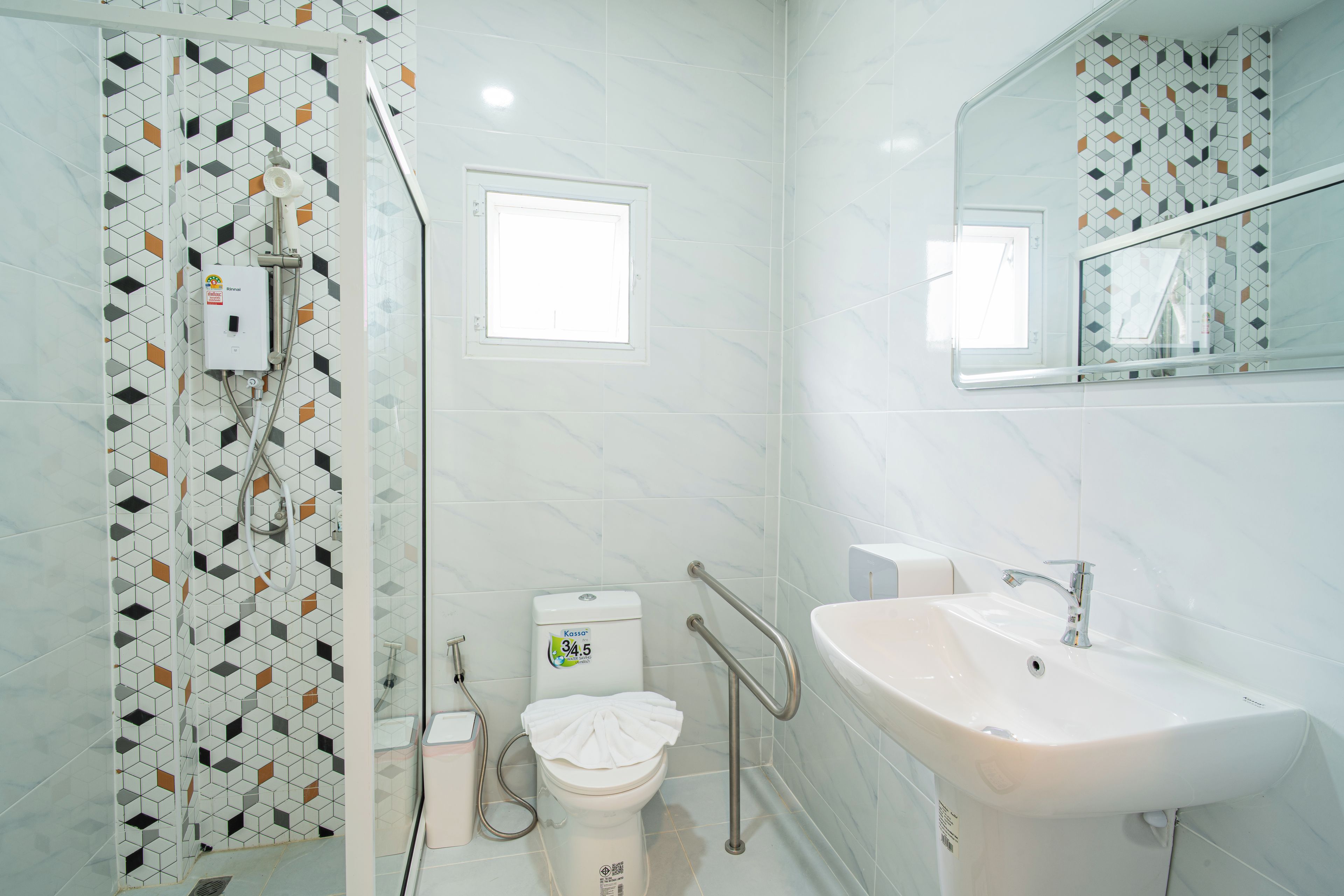 Un baño moderno con ducha, inodoro y lavamanos.