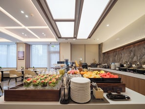 A buffet setup with various food items and utensils. - Hotel X Atour Urbs Shenyang (Shenyang)