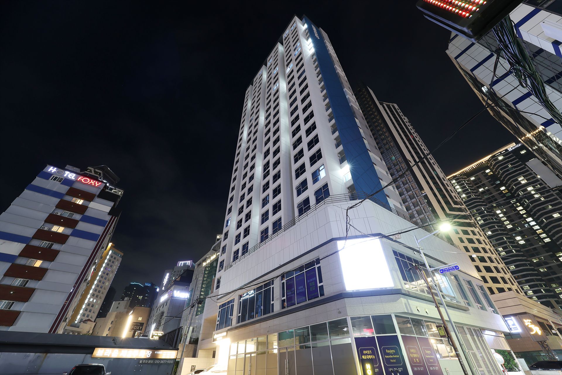 A high-rise hotel with multiple floors, large windows, and a prominent sign.