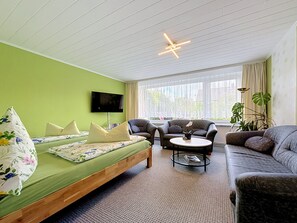 A room with a bed, two sofas, a coffee table, and a TV. - Apartment Meyer by Interhome (Raben Steinfeld)