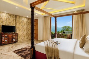 A bedroom with a four-poster bed, a television on a wooden cabinet, and a view of the outdoors. - ELIVAAS Signature SECRET ESCAPE Maharaj (Solan)